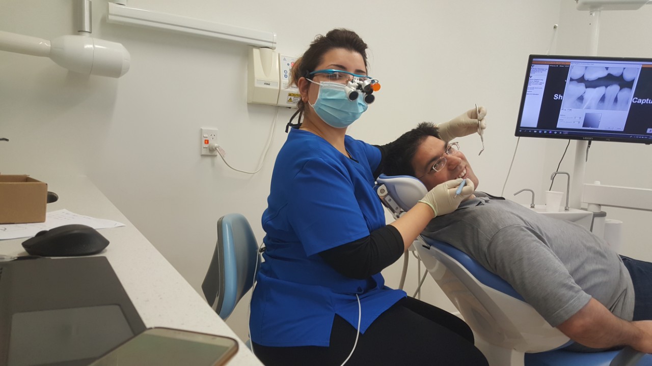 Dentist with patient Nova Dental Care
