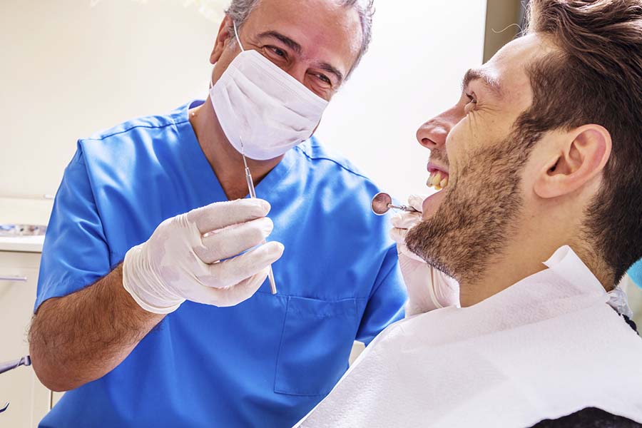 Dentist With Patient in Surgery